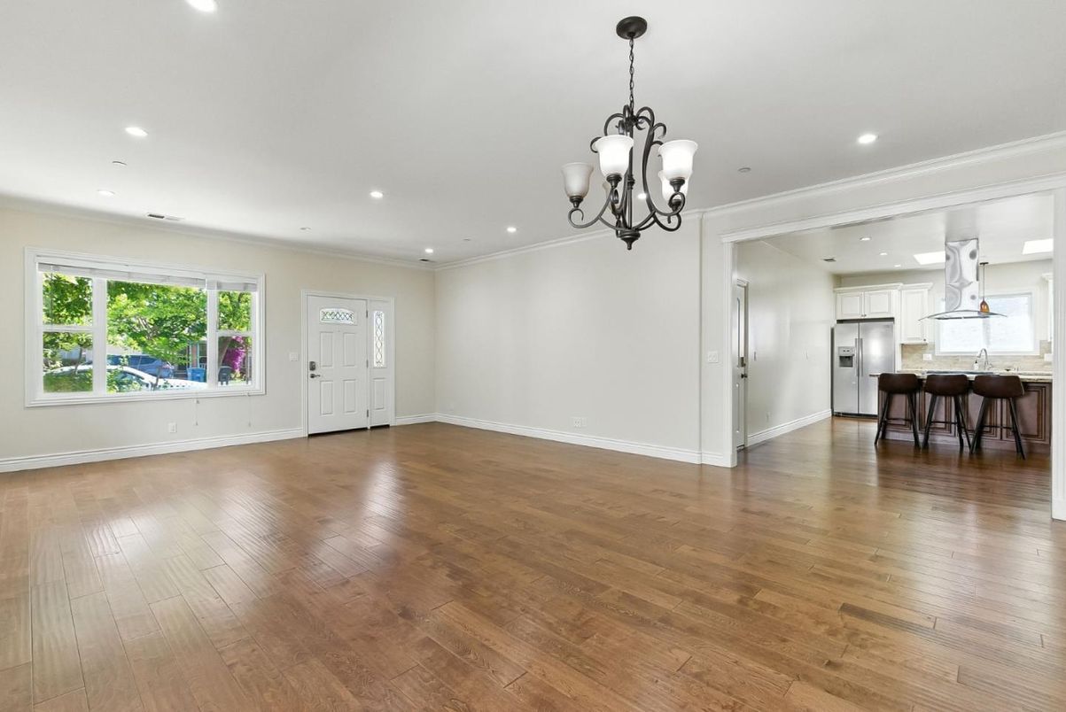 Chandelier, Empty room, Interior, Kitchen, Pendant Lights, Recessed Lighting, Stainless Steel Appliances, Wood Texture Flooring
