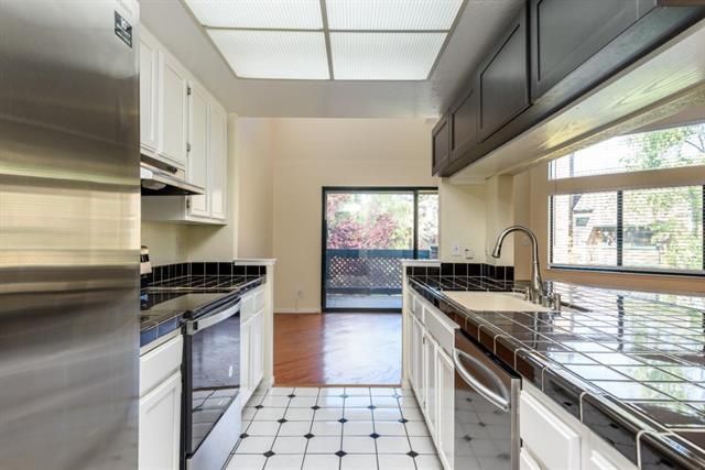 Interior, Kitchen, Stainless Steel Appliances, Tile Countertops, Wood Texture Flooring