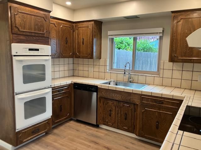 Interior, Kitchen, Recessed Lighting, Stainless Steel Appliances, Tile Countertops, Wood Texture Flooring