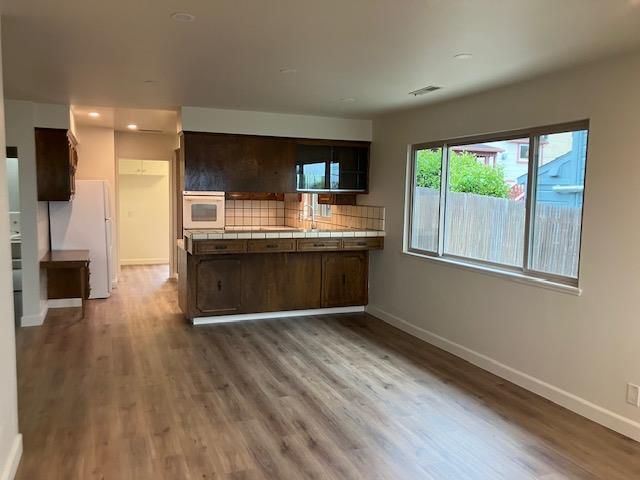 Interior, Kitchen, Recessed Lighting, Tile Countertops, Wood Texture Flooring