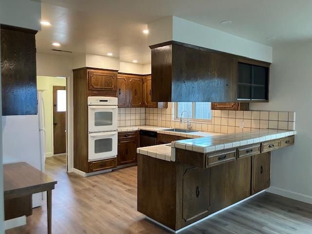 Interior, Kitchen, Recessed Lighting, Tile Countertops, Wood Texture Flooring
