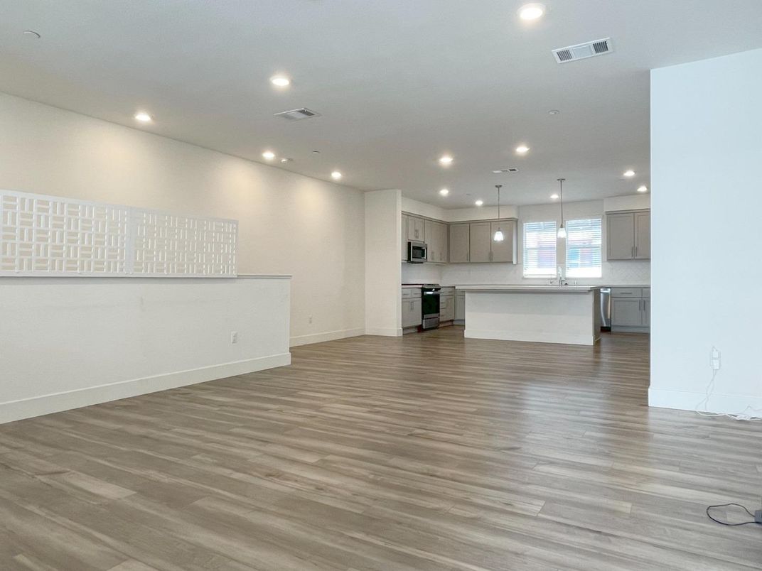 Empty room, Interior, Kitchen, Pendant Lights, Recessed Lighting, Stainless Steel Appliances, Wood Texture Flooring