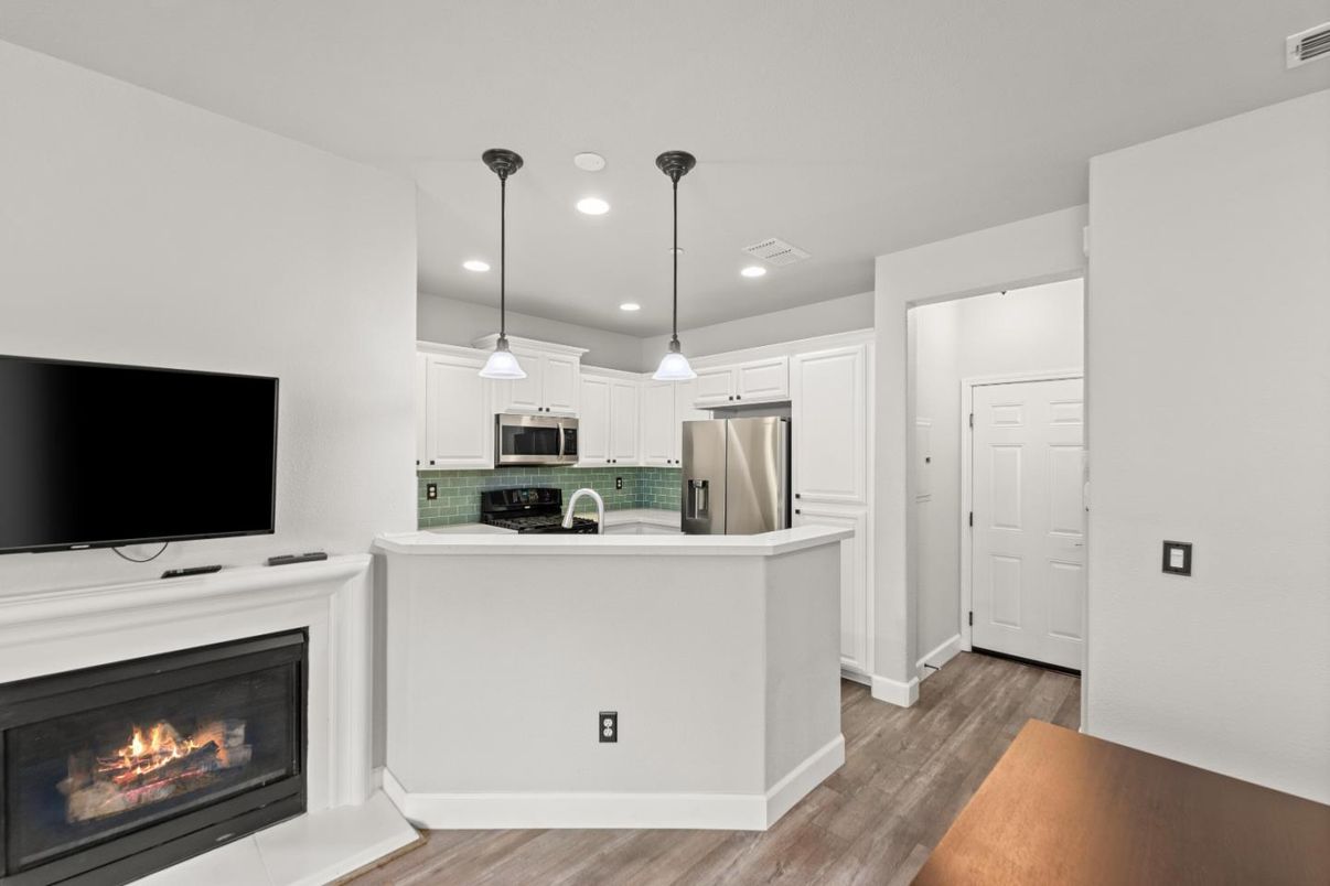 Fireplace, Interior, Kitchen, Pendant Lights, Recessed Lighting, Stainless Steel Appliances, Wood Texture Flooring