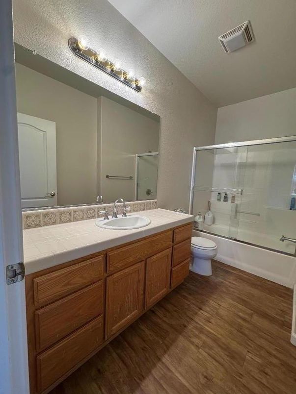 Bathroom, Dual Sink Vanities, Glass Shower, Interior, Tile Countertops, Wood Texture Flooring