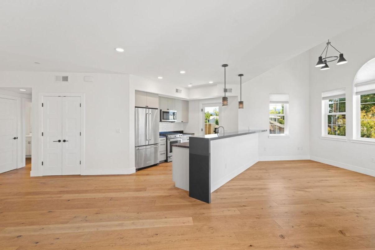 Empty room, Interior, Kitchen, Pendant Lights, Recessed Lighting, Stainless Steel Appliances, Wood Texture Flooring