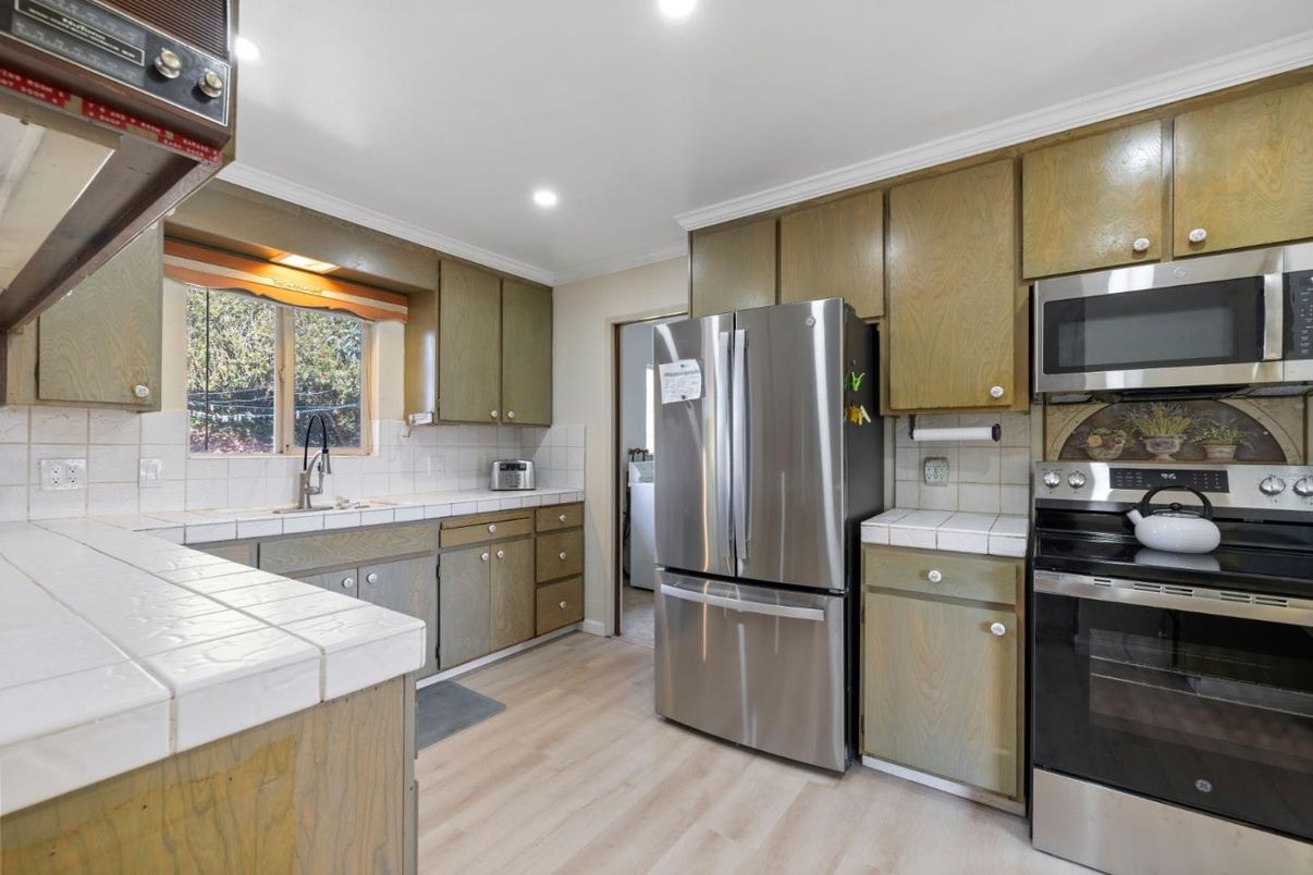 Interior, Kitchen, Recessed Lighting, Stainless Steel Appliances, Tile Countertops, Wood Texture Flooring