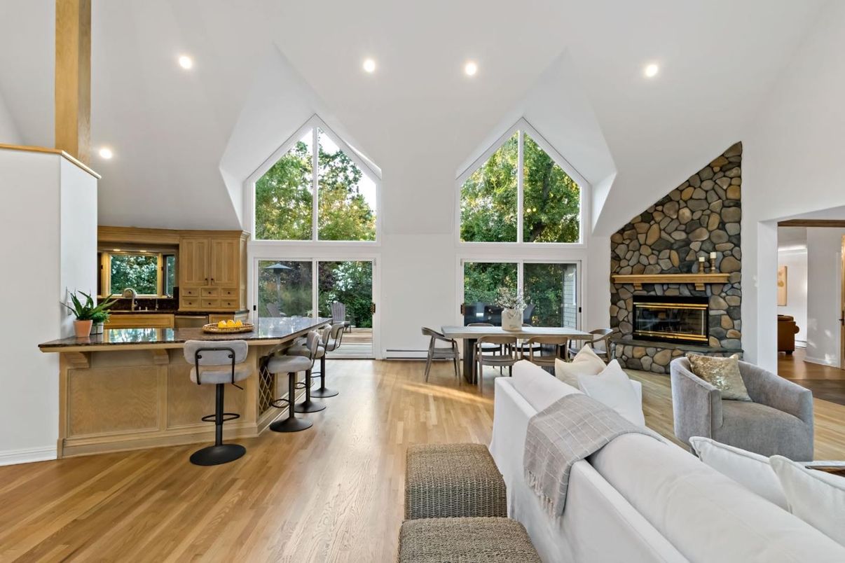 Dining room, Fireplace, Interior, Living room, Recessed Lighting, Stone Walls, Wood Texture Flooring