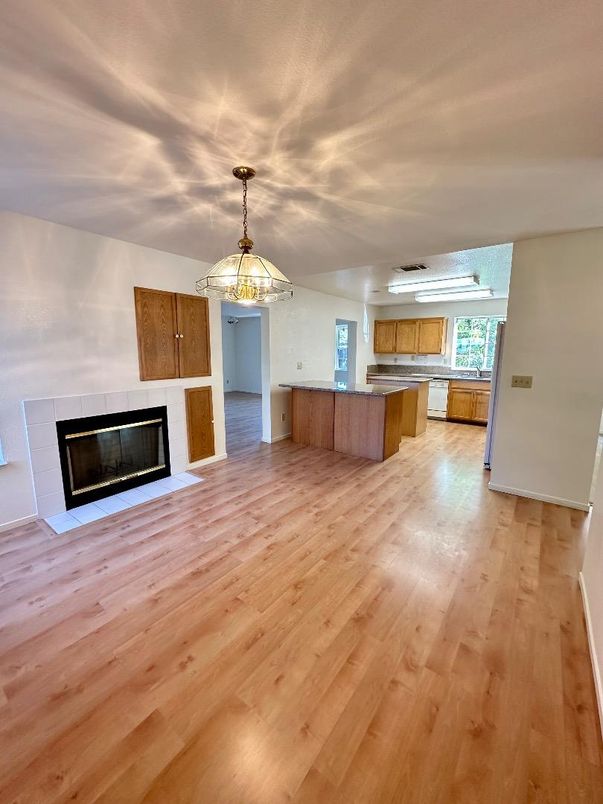 Empty room, Fireplace, Interior, Kitchen, Pendant Lights, Wood Texture Flooring