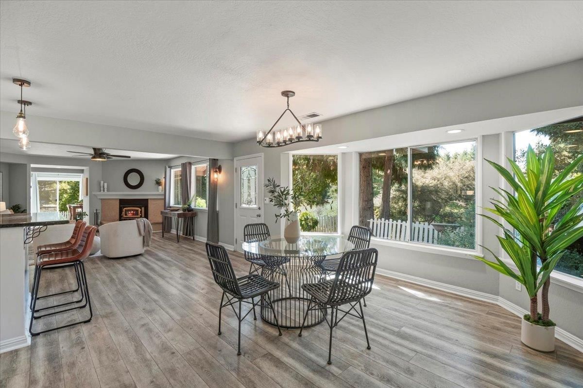 Chandelier, Dining room, Fireplace, Interior, Living room, Pendant Lights, Recessed Lighting, Wood Texture Flooring