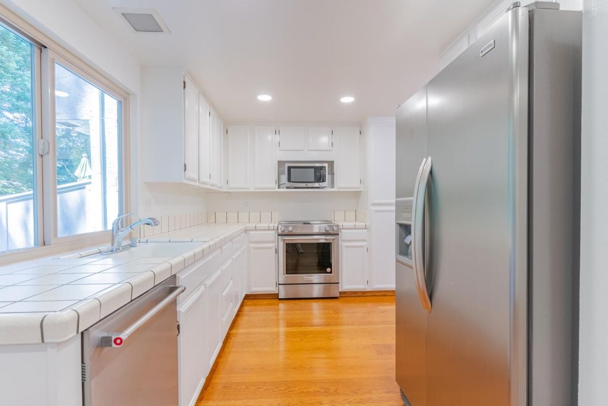 Interior, Kitchen, Recessed Lighting, Stainless Steel Appliances, Tile Countertops, Wood Texture Flooring