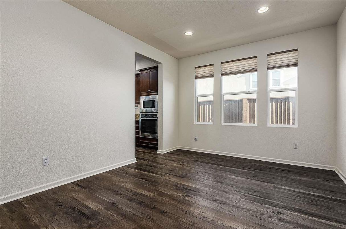 Empty room, Interior, Kitchen, Recessed Lighting, Stainless Steel Appliances, Wood Texture Flooring