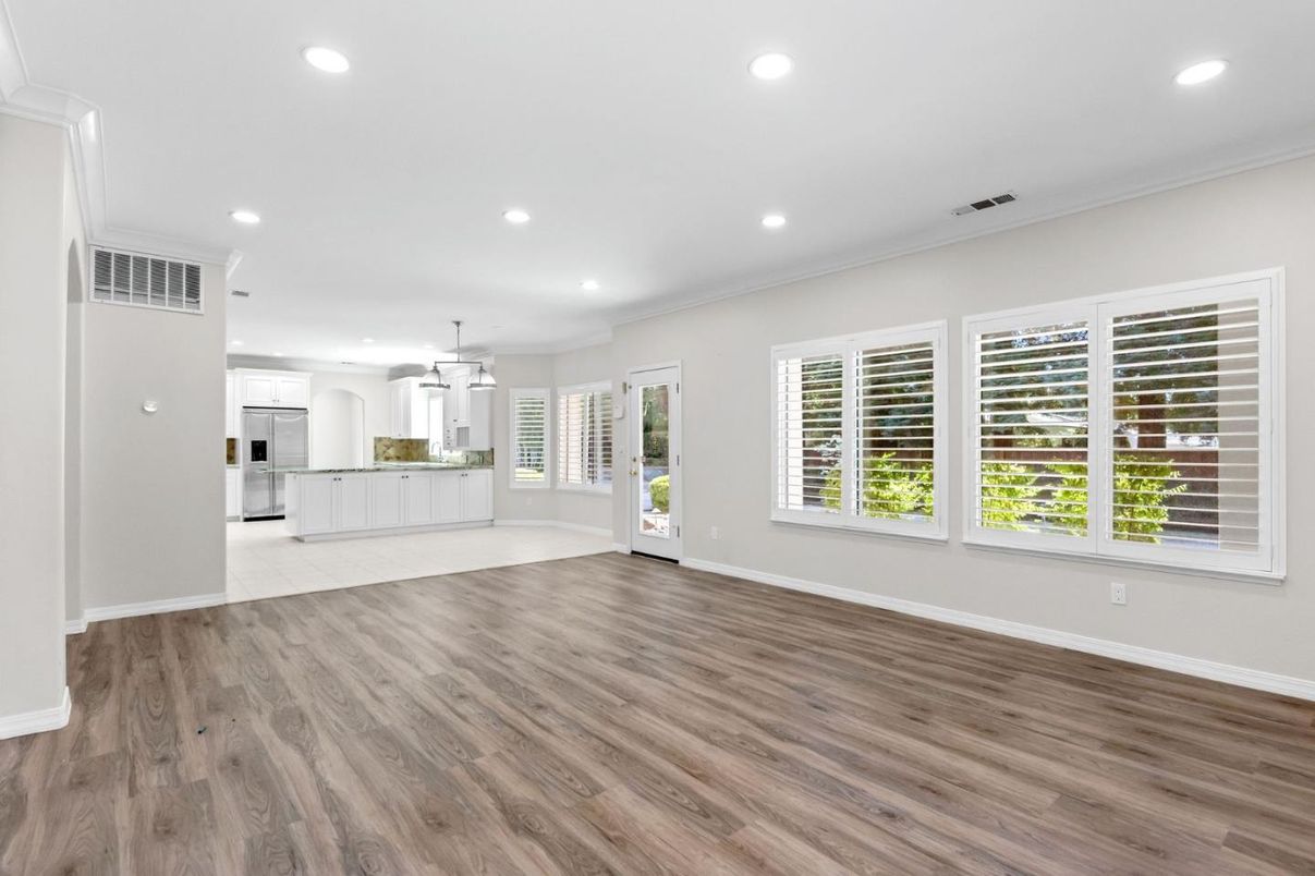 Empty room, Interior, Kitchen, Pendant Lights, Recessed Lighting, Stainless Steel Appliances, Wood Texture Flooring