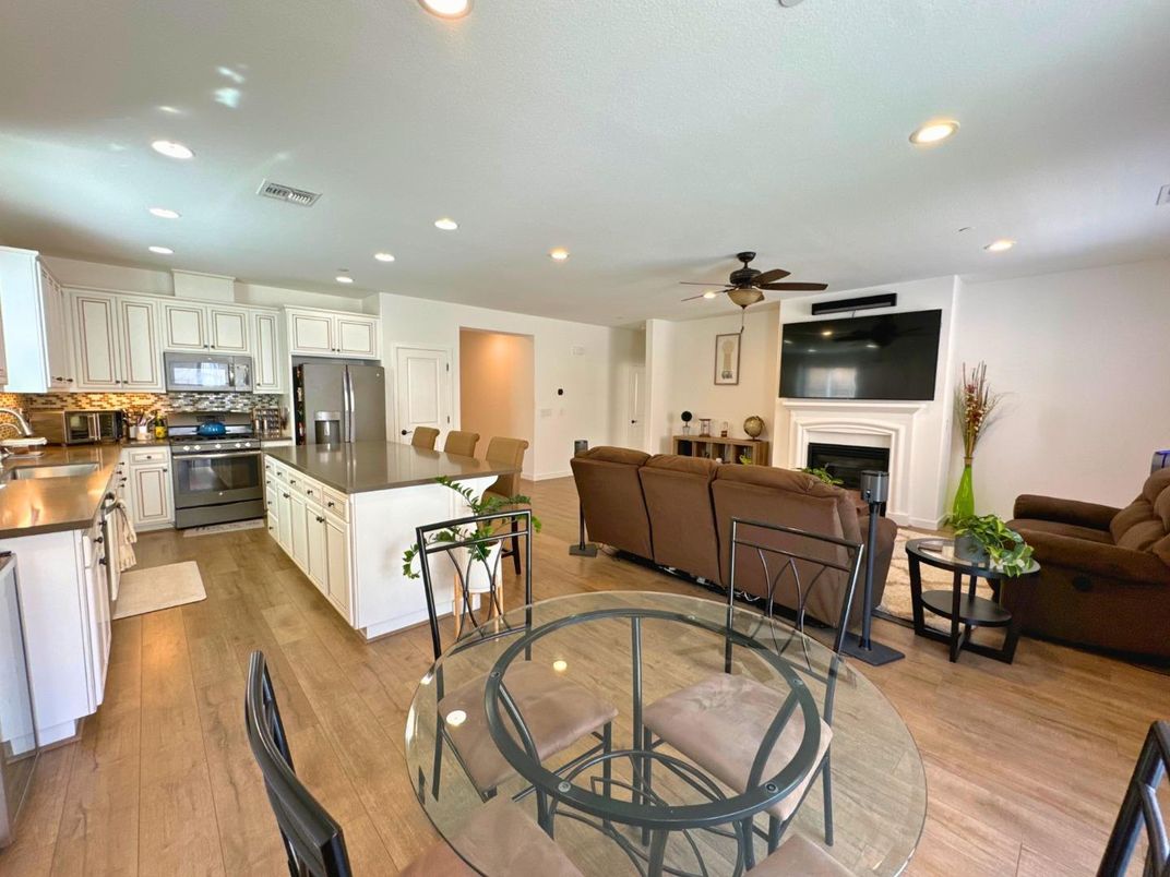Dining room, Fireplace, Interior, Kitchen, Living room, Recessed Lighting, Stainless Steel Appliances, Wood Texture Flooring