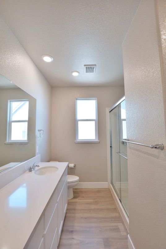 Bathroom, Dual Sink Vanities, Glass Shower, Interior, Recessed Lighting, Wood Texture Flooring