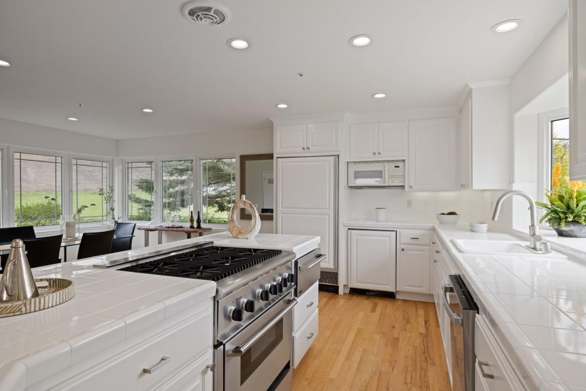 Dining room, Interior, Kitchen, Recessed Lighting, Stainless Steel Appliances, Tile Countertops, Wood Texture Flooring