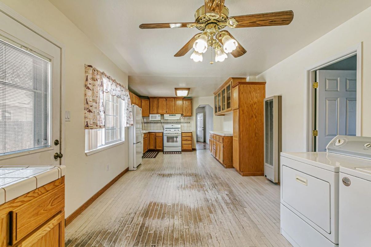 Interior, Kitchen, Tile Countertops, Washer, Wood Texture Flooring