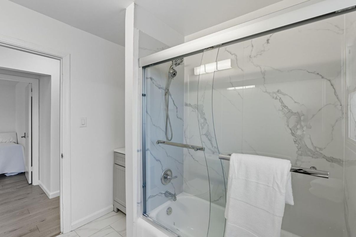 Bathroom, Glass Shower, Interior, Marble Walls, Wood Texture Flooring