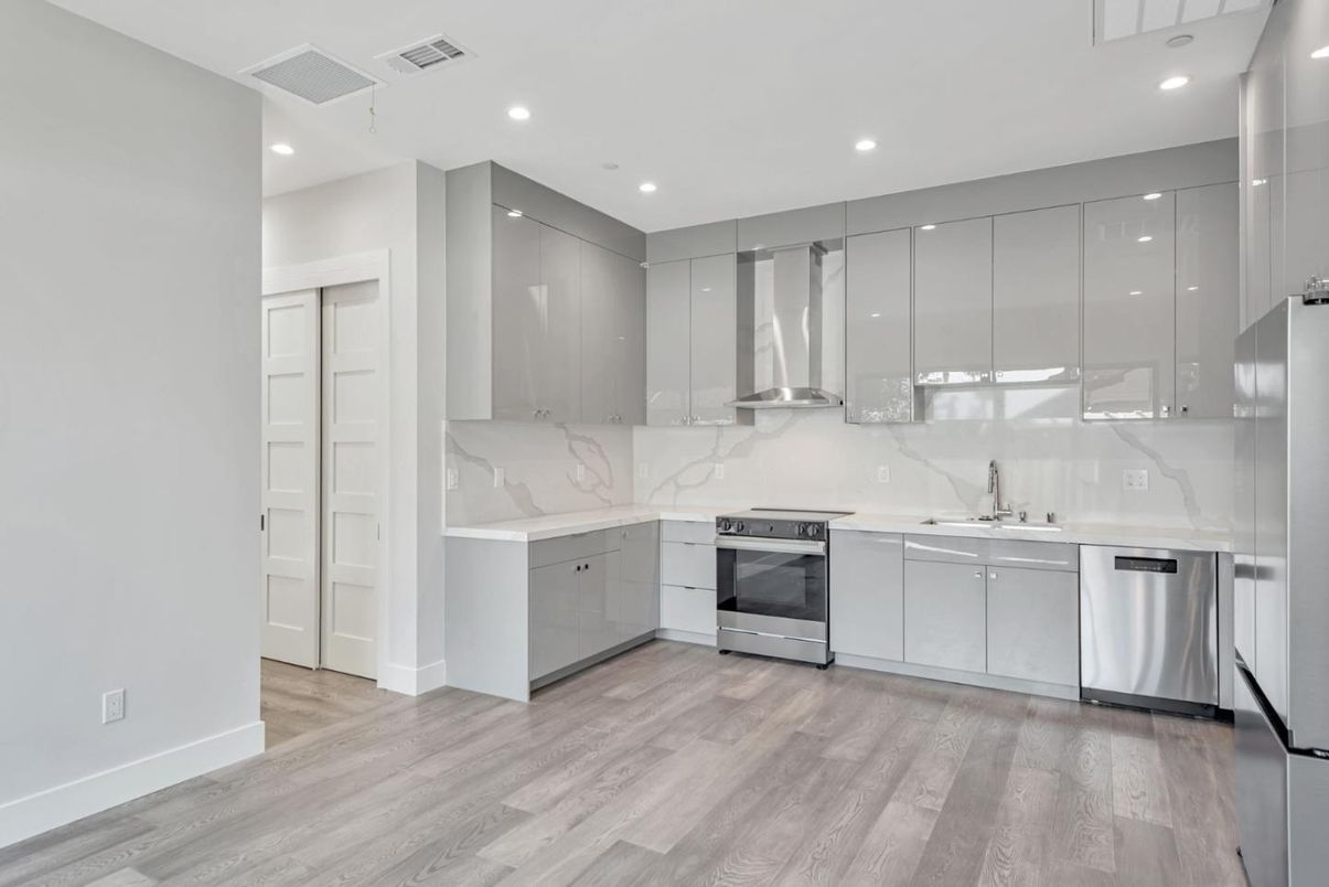 Interior, Kitchen, Marble Walls, Recessed Lighting, Stainless Steel Appliances, Wood Texture Flooring