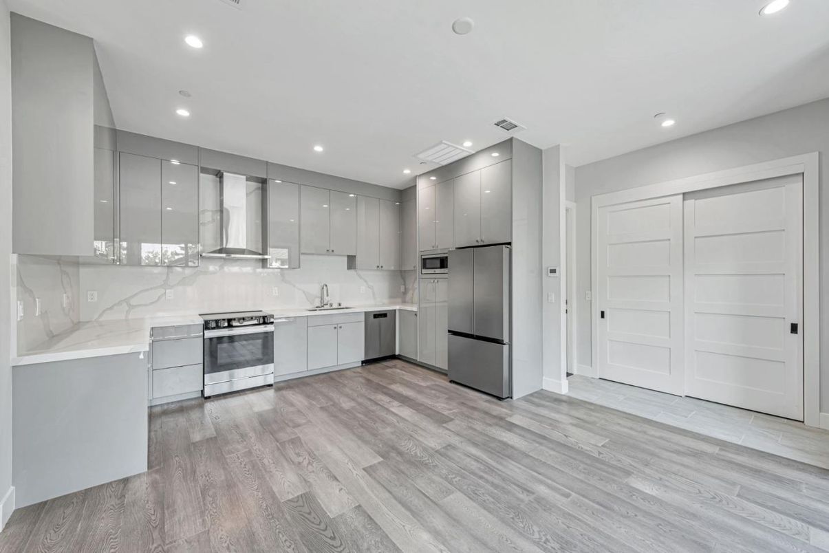 Interior, Kitchen, Marble Walls, Recessed Lighting, Stainless Steel Appliances, Wood Texture Flooring