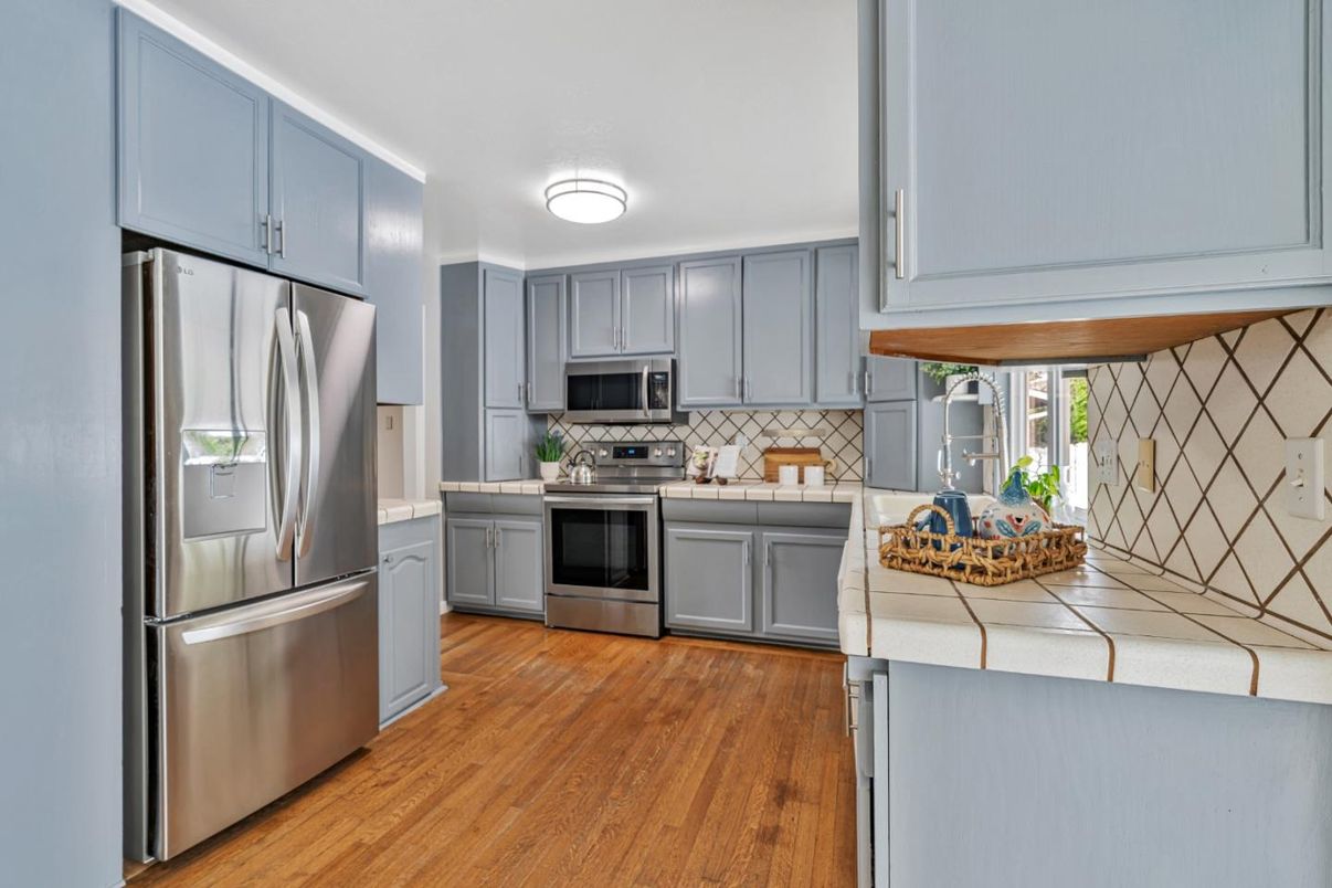 Interior, Kitchen, Stainless Steel Appliances, Tile Countertops, Wood Texture Flooring