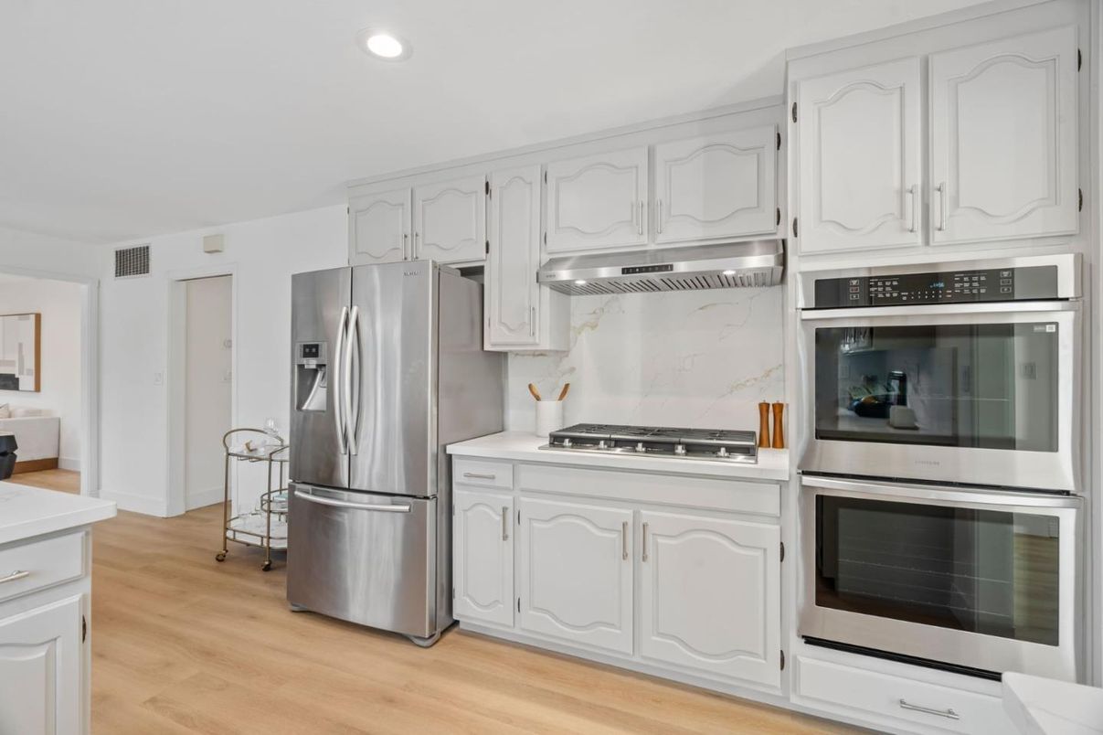 Interior, Kitchen, Marble Walls, Recessed Lighting, Stainless Steel Appliances, Wood Texture Flooring