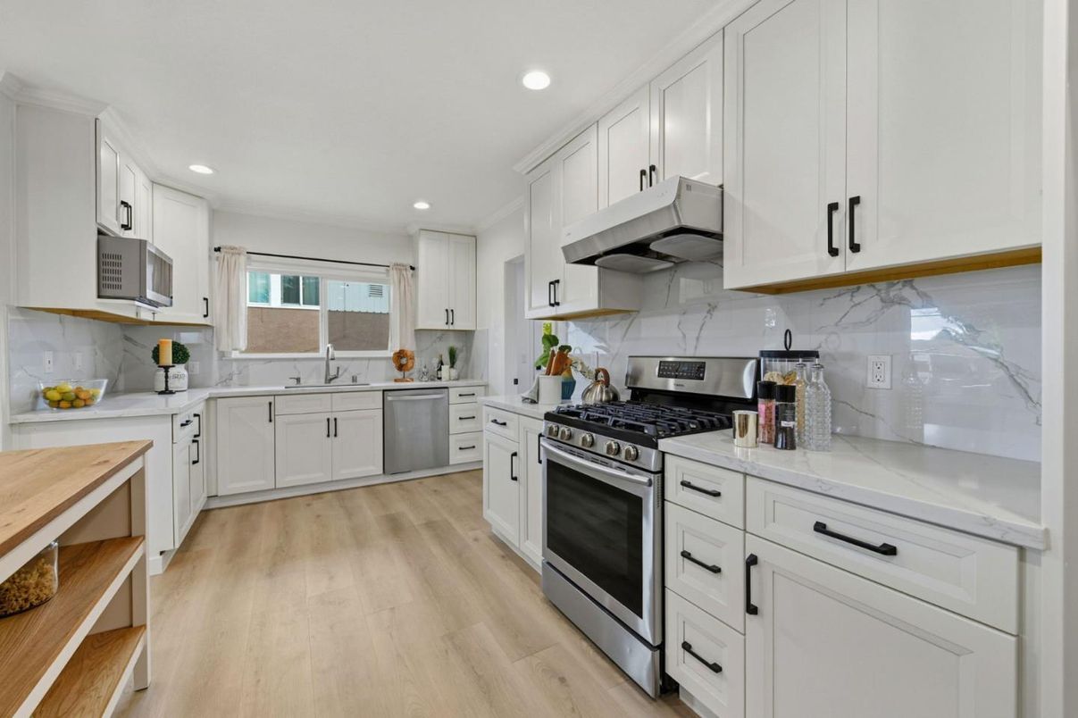 Interior, Kitchen, Marble Walls, Recessed Lighting, Stainless Steel Appliances, Wood Texture Flooring