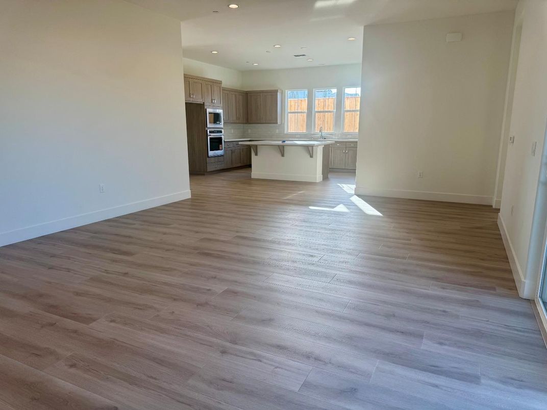 Empty room, Interior, Kitchen, Recessed Lighting, Stainless Steel Appliances, Wood Texture Flooring