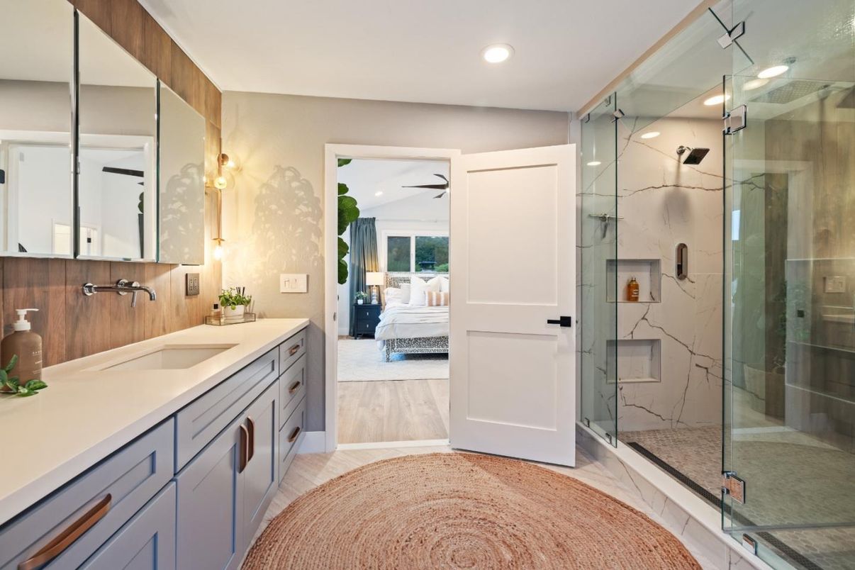 Bathroom, Bedroom, Dual Sink Vanities, Glass Shower, Interior, Marble Walls, Recessed Lighting, Wood Texture Flooring