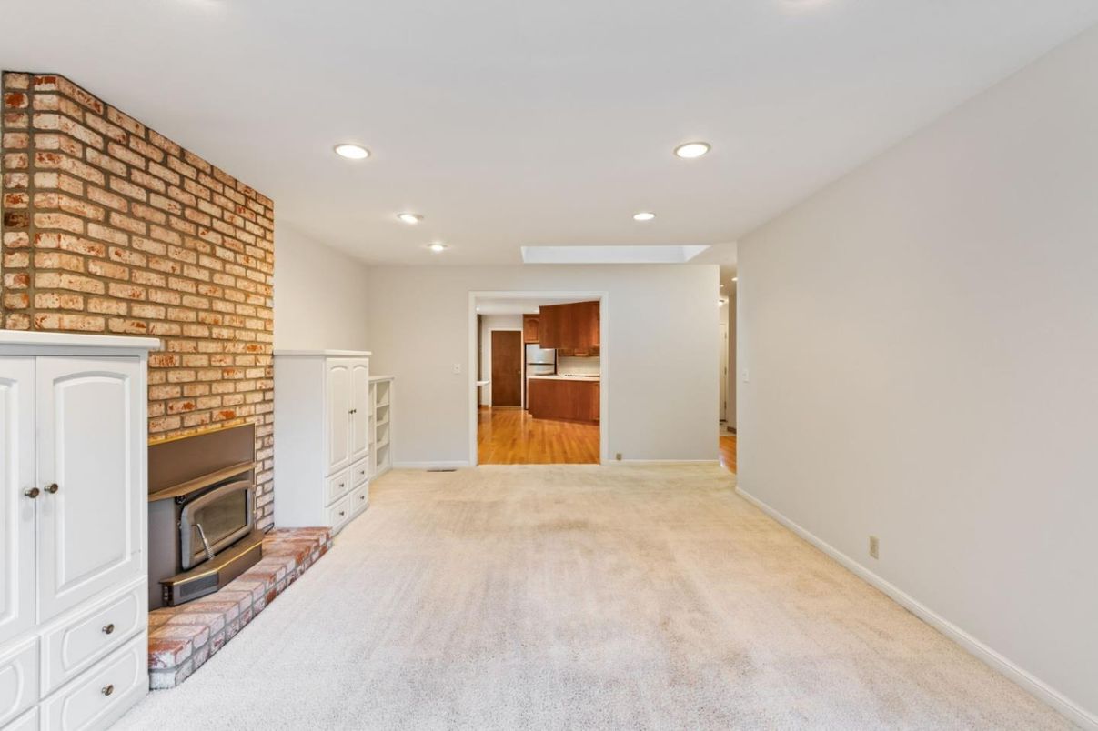 Empty room, Fireplace, Interior, Recessed Lighting, Stone Walls, Wood Texture Flooring