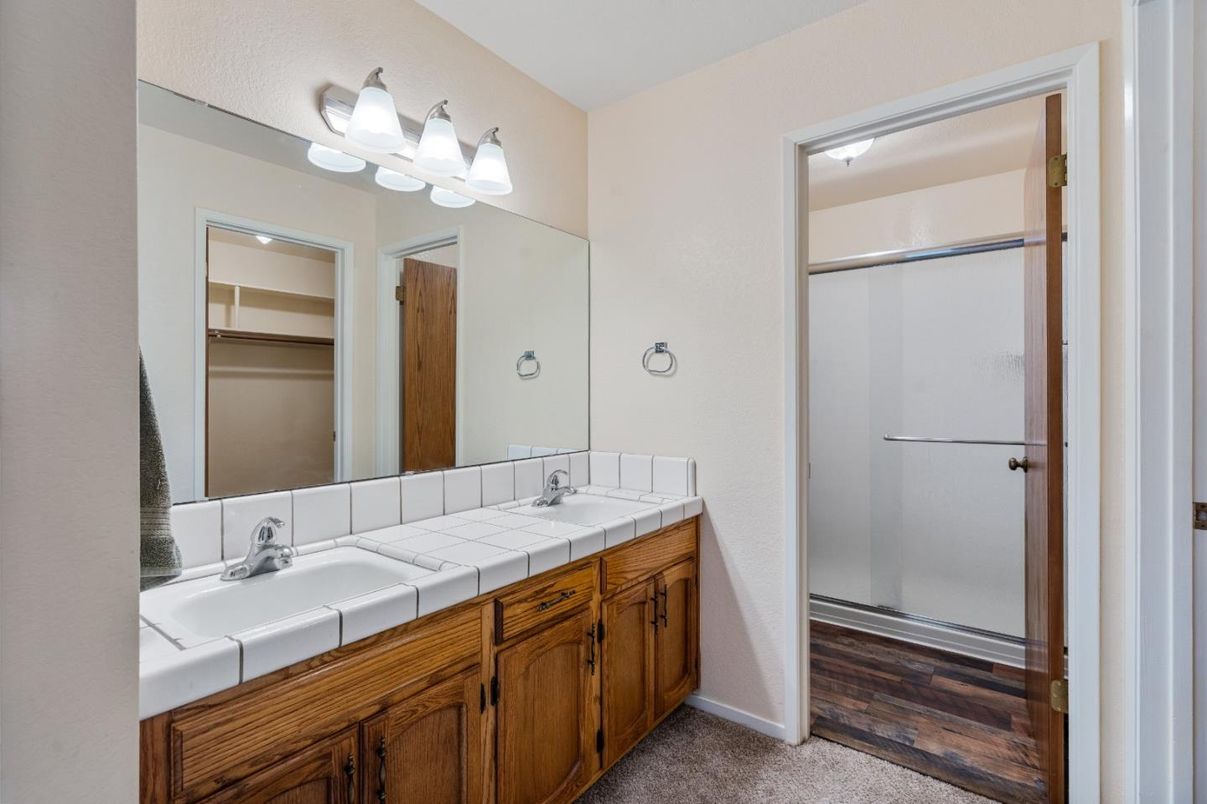 Bathroom, Dual Sink Vanities, Glass Shower, Interior, Tile Countertops, Wood Texture Flooring