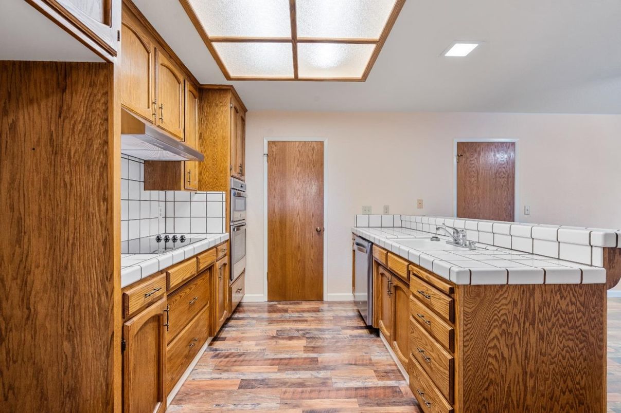 Interior, Kitchen, Recessed Lighting, Tile Countertops, Wood Texture Flooring