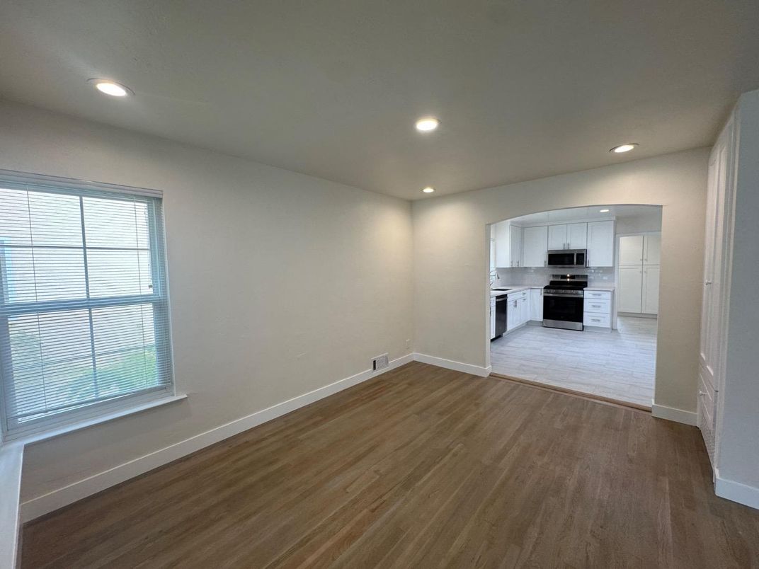 Empty room, Interior, Kitchen, Recessed Lighting, Stainless Steel Appliances, Wood Texture Flooring