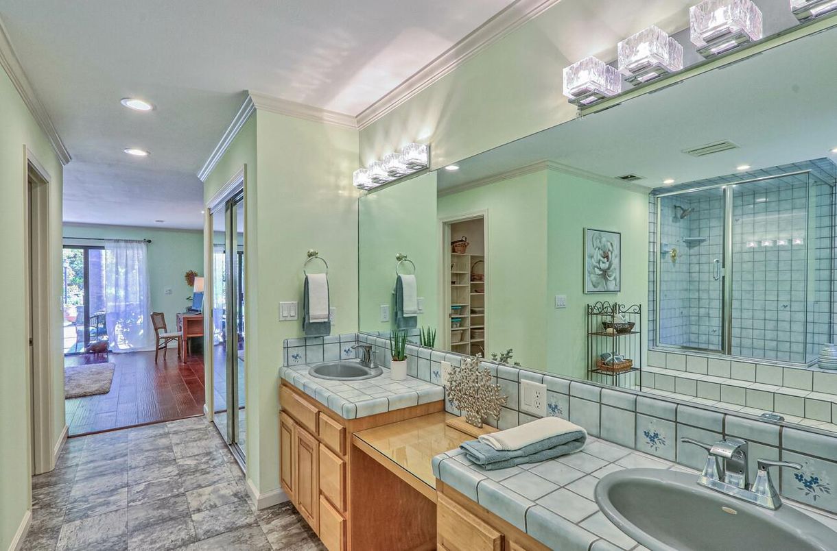 Bathroom, Dual Sink Vanities, Glass Shower, Interior, Recessed Lighting, Tile Countertops, Wood Texture Flooring