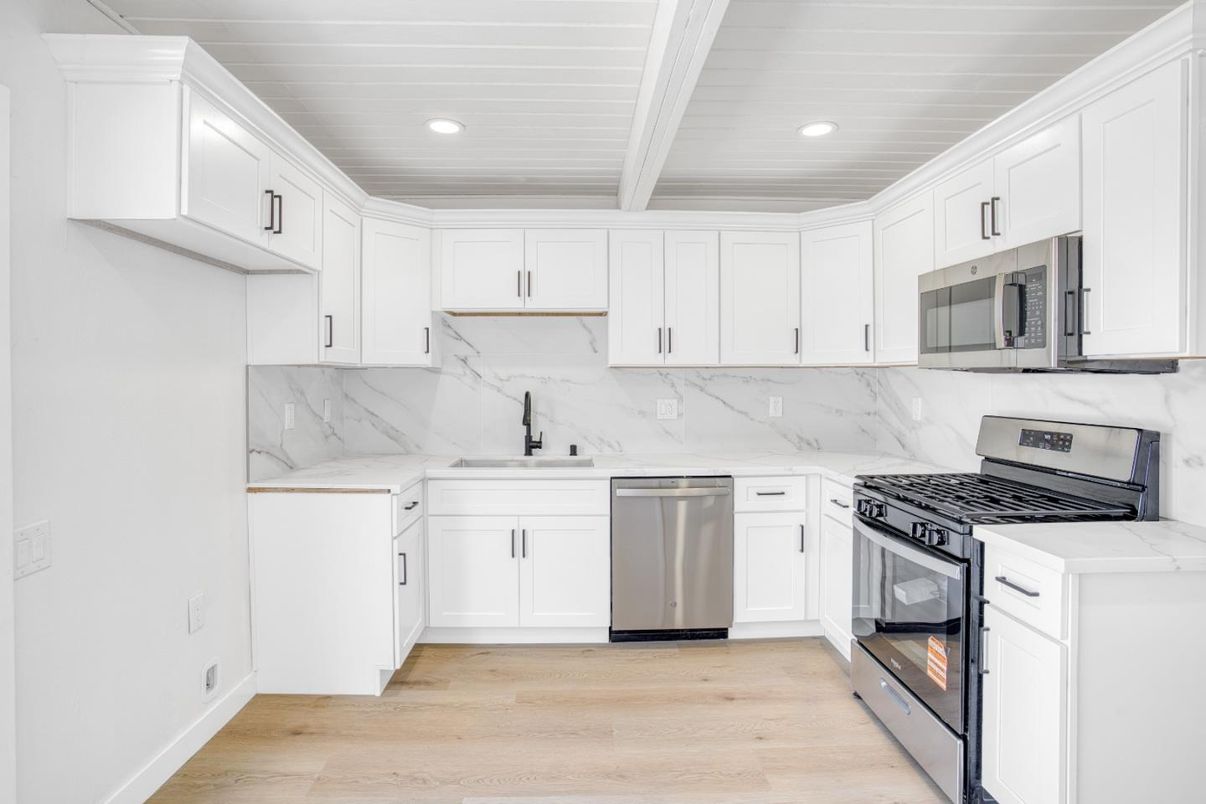 Interior, Kitchen, Marble Walls, Recessed Lighting, Stainless Steel Appliances, Wood Texture Flooring