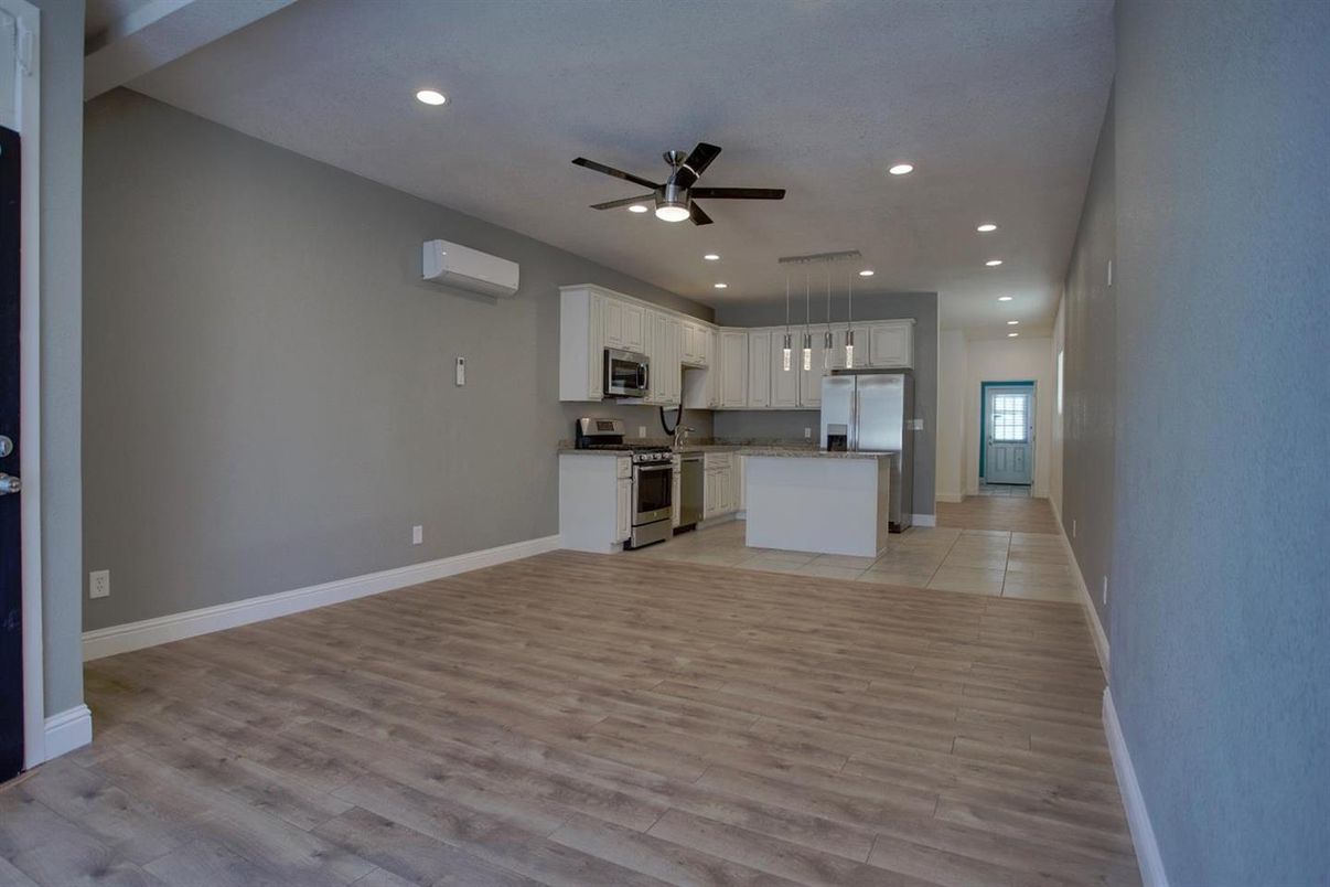Empty room, Interior, Kitchen, Pendant Lights, Recessed Lighting, Stainless Steel Appliances, Wood Texture Flooring