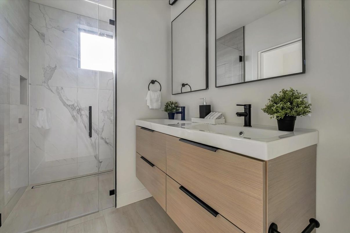 Bathroom, Dual Sink Vanities, Glass Shower, Interior, Marble Walls, Wood Texture Flooring