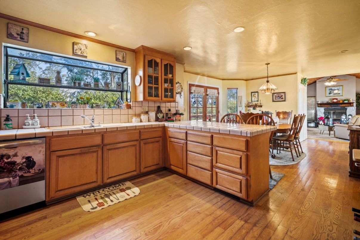 Dining room, Fireplace, Interior, Kitchen, Pendant Lights, Recessed Lighting, Tile Countertops, Wood Texture Flooring