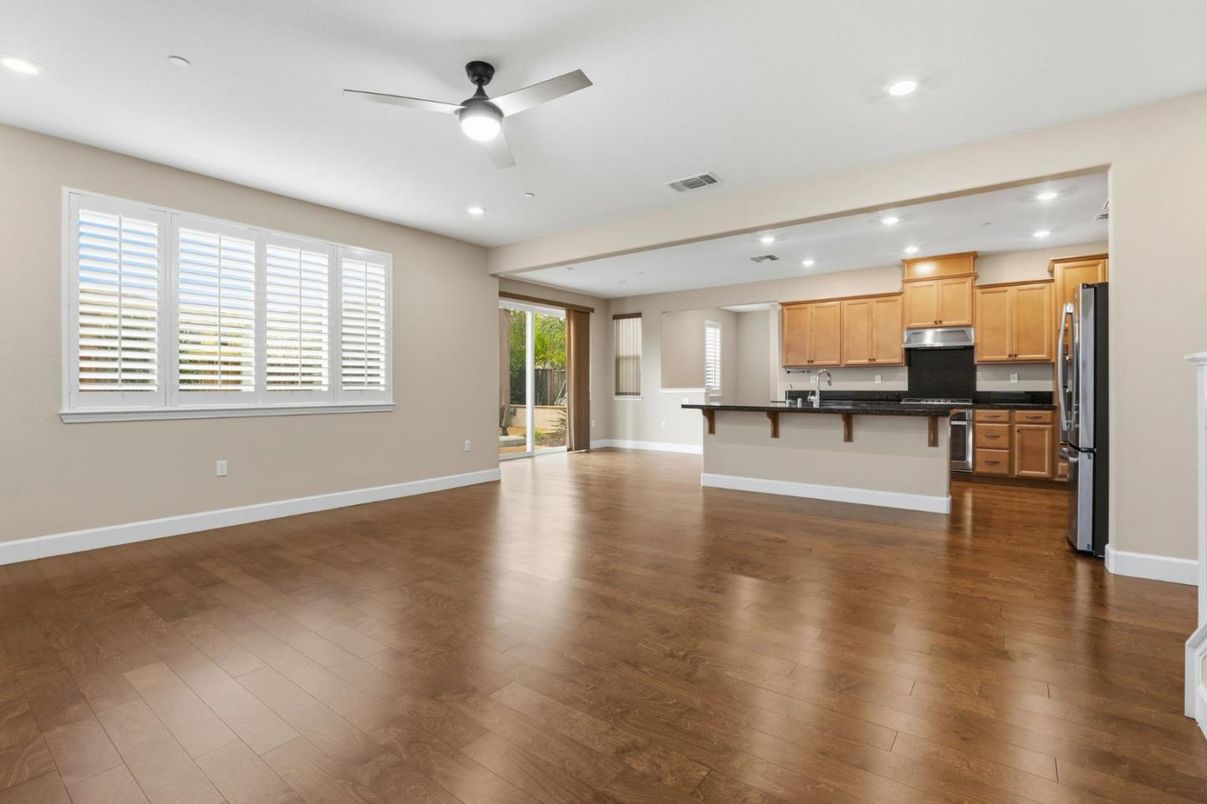 Empty room, Interior, Kitchen, Recessed Lighting, Stainless Steel Appliances, Wood Texture Flooring