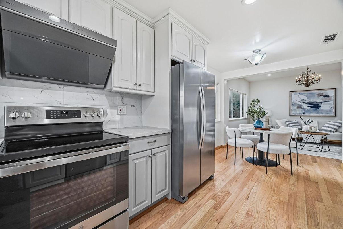 Chandelier, Dining room, Interior, Kitchen, Marble Walls, Recessed Lighting, Stainless Steel Appliances, Wood Texture Flooring