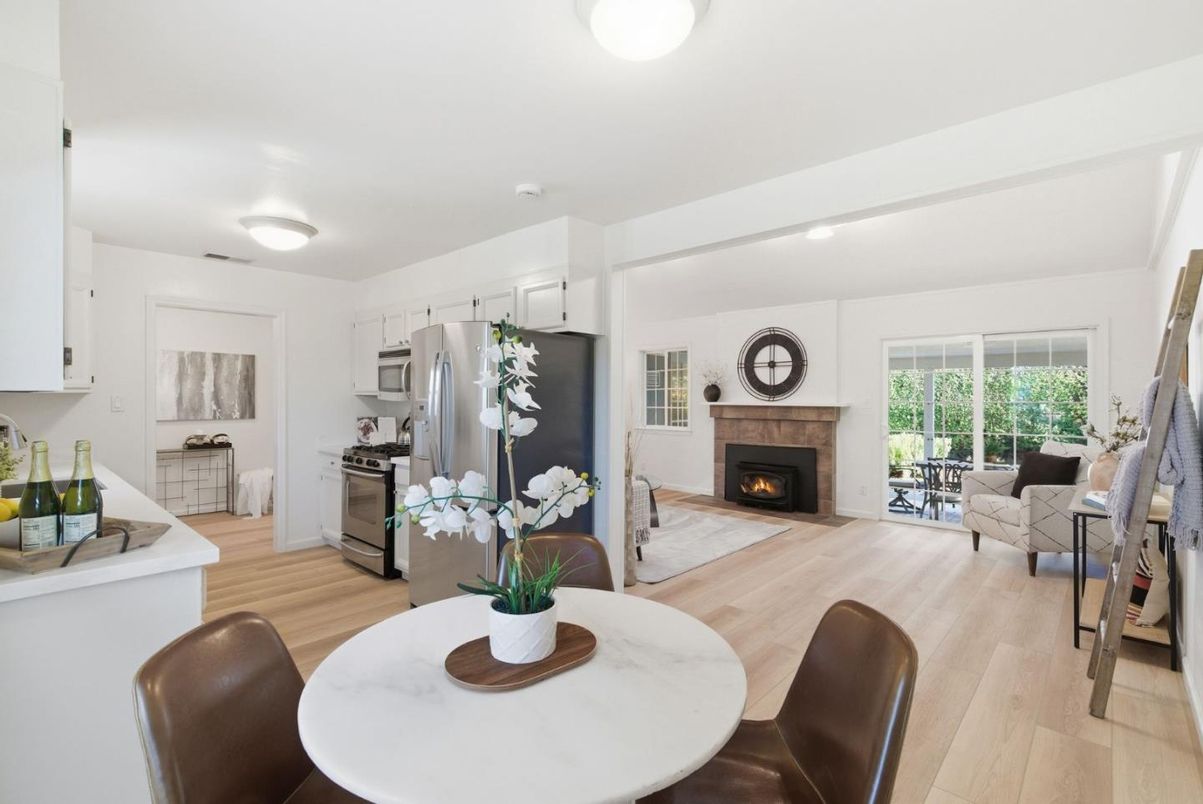 Dining room, Fireplace, Interior, Kitchen, Living room, Recessed Lighting, Stainless Steel Appliances, Wood Texture Flooring