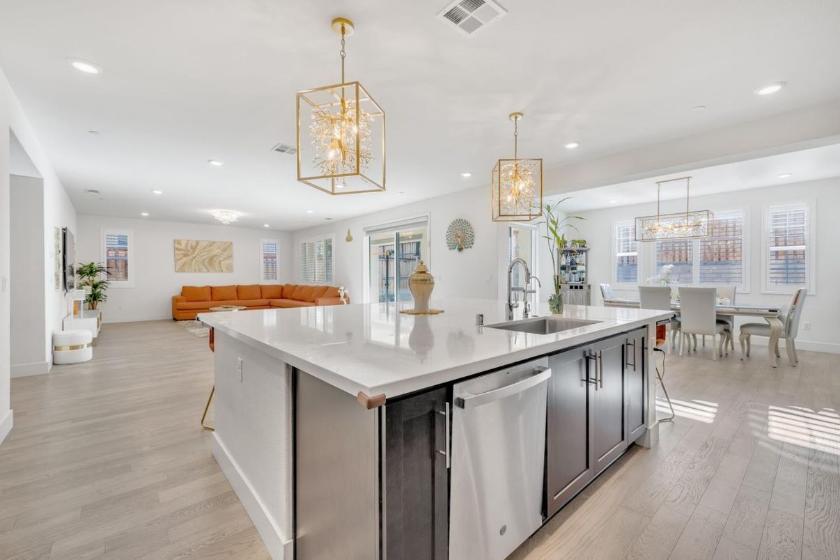 Chandelier, Dining room, Interior, Kitchen, Living room, Pendant Lights, Recessed Lighting, Stainless Steel Appliances, Wood Texture Flooring