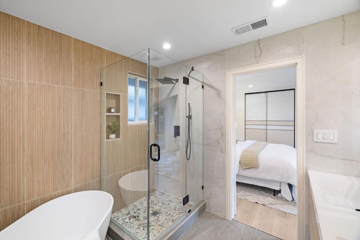 Bathroom, Free Standing Baths, Glass Shower, Interior, Marble Walls, Recessed Lighting, Wood Texture Flooring