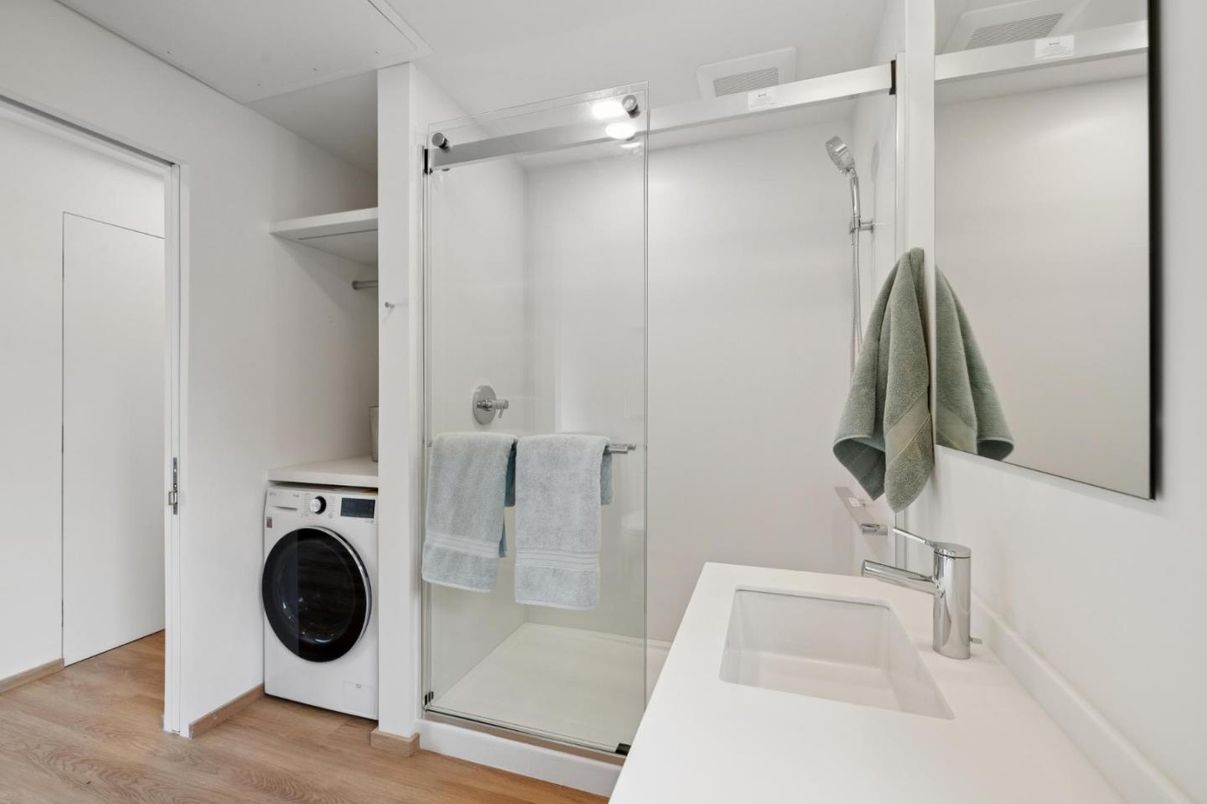 Bathroom, Glass Shower, Interior, Washer, Wood Texture Flooring