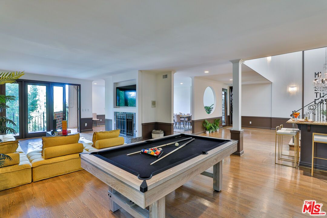 Billiard Table, Fireplace, Game Room, Interior, Living room, Pendant Lights, Recessed Lighting, Wood Texture Flooring