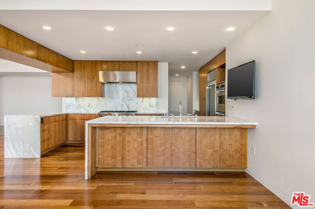 Interior, Kitchen, Marble Walls, Recessed Lighting, Stainless Steel Appliances, Wood Texture Flooring