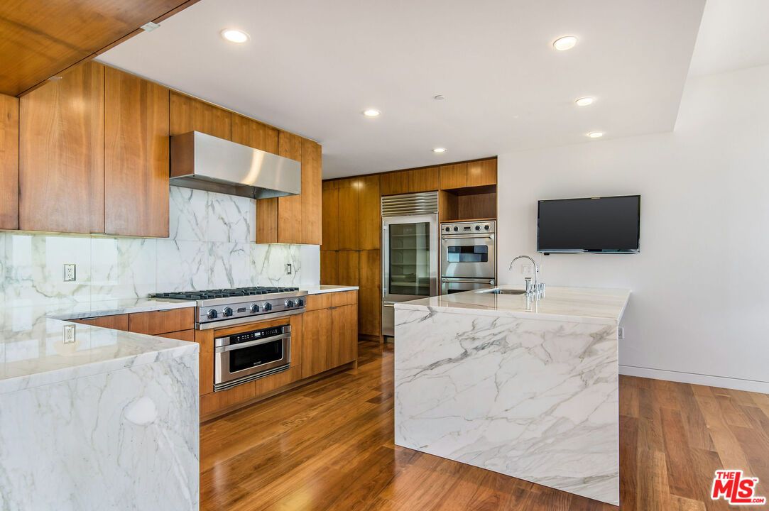 Interior, Kitchen, Marble Walls, Recessed Lighting, Stainless Steel Appliances, Wood Texture Flooring