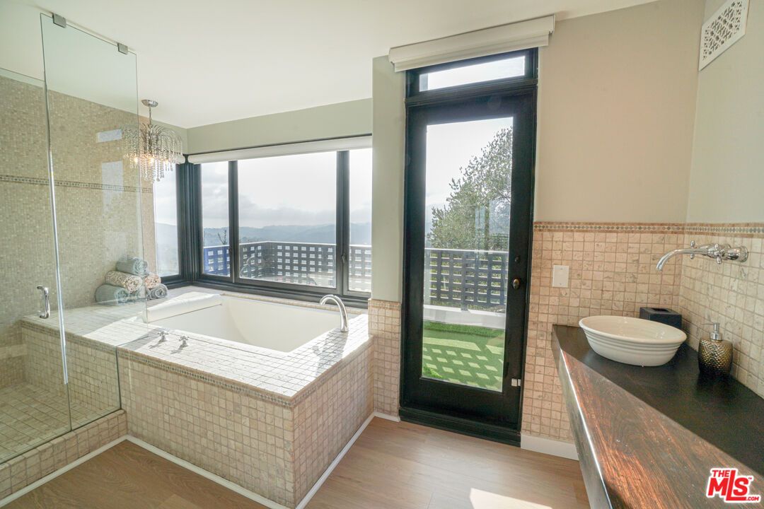 Bathroom, Chandelier, Dual Sink Vanities, Glass Shower, Interior, Wood Texture Flooring