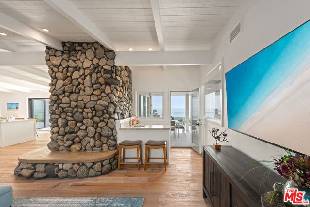 Fireplace, Interior, Recessed Lighting, Stone Walls, Water, Wood Texture Flooring