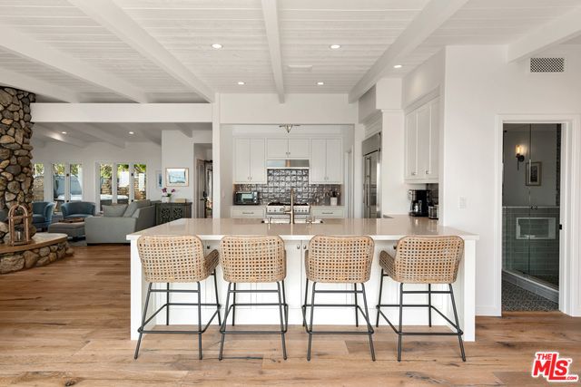 Fireplace, Interior, Kitchen, Living room, Recessed Lighting, Stainless Steel Appliances, Stone Walls, Wood Texture Flooring