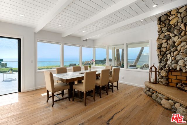 Dining room, Fireplace, Interior, Recessed Lighting, Stone Walls, Water, Wood Texture Flooring